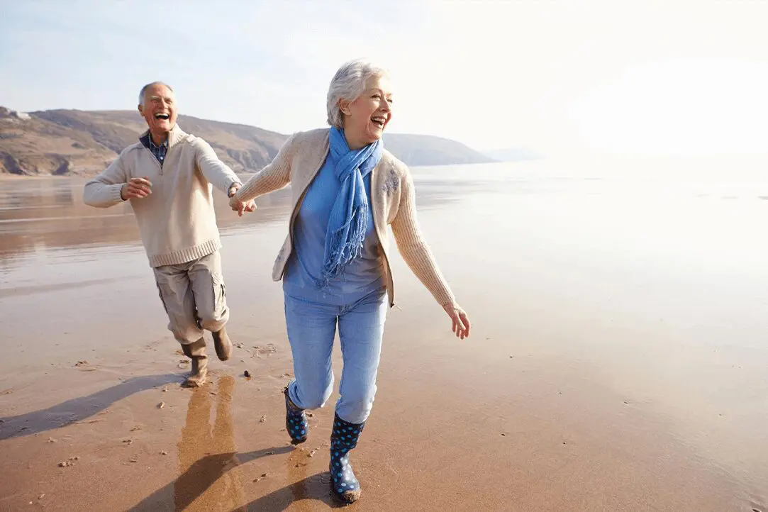 A man and woman walking on the beach